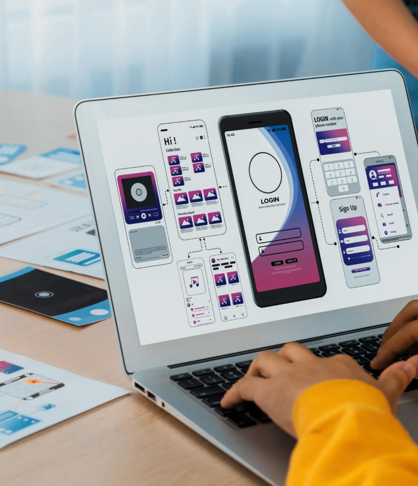 Mobile app developer designing a smartphone application interface and testing app features